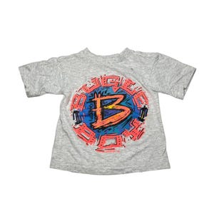 May include: A gray short-sleeved t-shirt with a colorful graphic of the word "BIG" in a circle with a large "B" in the center.