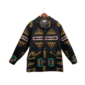 May include: A black wool jacket with a geometric pattern in shades of brown, green, blue, and purple. The jacket has a button-up front and two pockets.