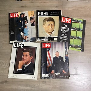 May include: A collection of vintage LIFE and POST magazines. The covers feature portraits of John F. Kennedy, Jacqueline Kennedy, and Lyndon B. Johnson. The magazines are from the 1960s and cover historical events.