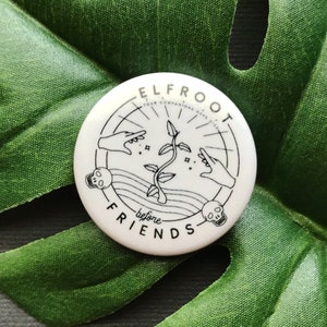 May include: White round pin with black line art of two hands reaching towards a plant with the text "ELFROOT YOUR COMPANIONS HAVE DIED before FRIENDS" around the outside.