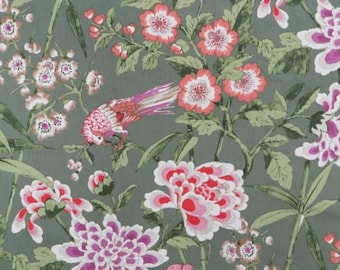 May include: Floral fabric with a pattern of pink and white flowers, green leaves, and a bird with pink and red feathers on a muted green background. The design features large peony-like blooms and smaller blossoms.