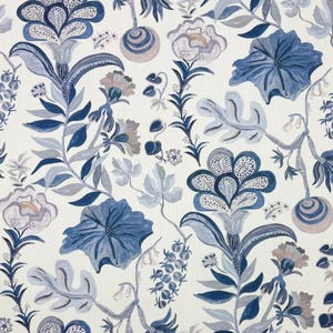 May include: Floral pattern fabric featuring a repeating design of stylized flowers and foliage in shades of blue, gray, and muted pink against a cream background. The design includes large, detailed blooms and delicate sprigs, creating a botanical theme.