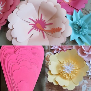 May include: A collection of paper flowers in various colors and styles, including pink, blue, yellow, and white. The flowers are layered and arranged in a decorative display.