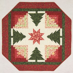 May include: A red, green and white quilted table runner with a star and Christmas tree design.