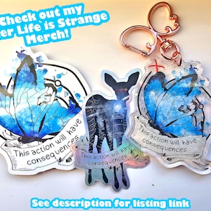 May include: Three iridescent acrylic keychains featuring a butterfly design with the text "This action will have consequences". The keychains are attached to a gold-coloured metal ring.