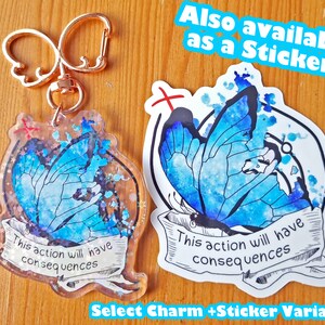 May include: A blue butterfly charm with glitter and the text "This action will have consequences" on a white background. The charm is attached to a gold key chain. The image also shows a sticker with the same design and text.