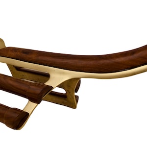 May include: A wine rack made from dark wood and brass. It has a curved wooden top and three cylindrical wooden holders. The frame is brass. The design is elegant and functional, suitable for storing wine bottles.