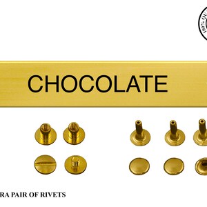 May include: Gold-colored metal plaque with the word "CHOCOLATE" engraved on it. The plaque comes with an extra pair of rivets for attaching it to a surface.
