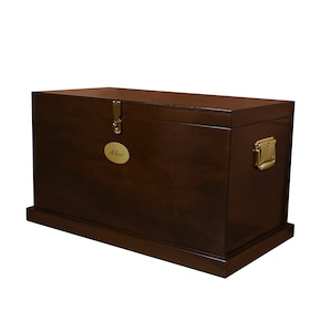 May include: A dark brown wooden storage chest with brass hardware and a brass nameplate that reads "Alan".