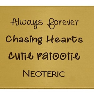 May include: Gold-coloured metal plaque with the text "Always forever", "Chasing Hearts", "Cutie patootie", and "NEOTERIC" engraved on it.
