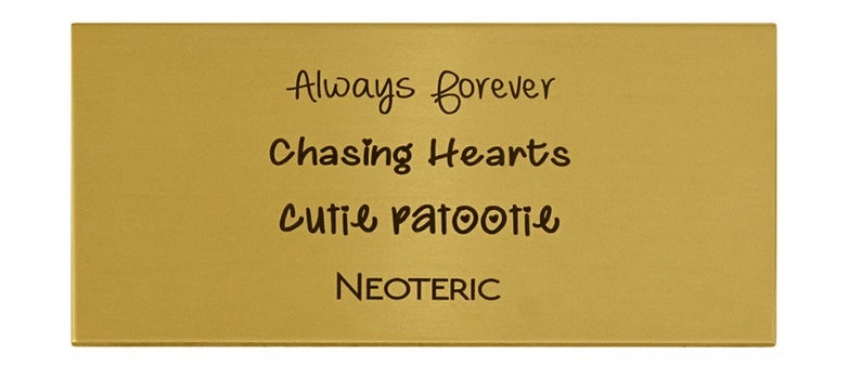 May include: Gold-coloured metal plaque with the text "Always forever", "Chasing Hearts", "Cutie patootie", and "NEOTERIC" engraved on it.
