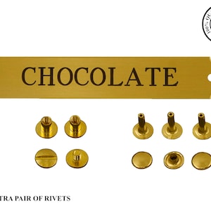 May include: Gold metal sign with the word "CHOCOLATE" engraved on it. The sign comes with a set of rivets for attaching it to a surface.