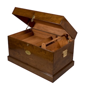 May include: A wooden storage chest with a hinged lid, open to reveal a divided interior. The chest has a brass latch and a brass nameplate with the word "Helen" engraved on it.