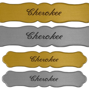 May include: Four decorative metal nameplates with a wavy edge. The nameplates are in two colors, gold and silver. Each nameplate has the word "Cherokee" written in a cursive font.