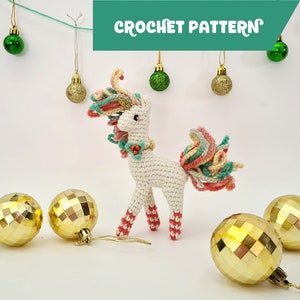 May include: A white crocheted unicorn with a pink, green, and yellow mane and tail. The unicorn is standing on a white surface with gold ornaments around it. The text "CROCHET PATTERN" is in the top center of the image.