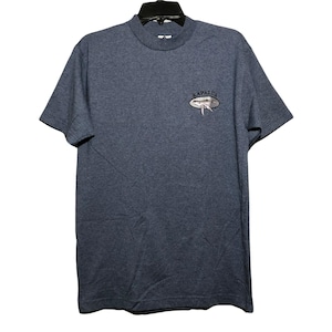 May include: A blue short-sleeved t-shirt with a small embroidered design on the chest. The design features the word "KAPALUA" above a stylized image of a whale. The shirt has a crew neck and is made of a soft material.