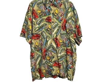 May include: A short-sleeved button-down shirt with a green background and a colorful print of cars, flags, and other designs. The shirt has a collar and a button-up front.