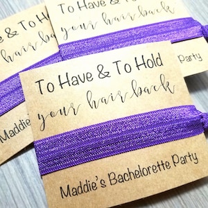 May include: Purple hair ties with brown cardstock tags that read "To Have & To Hold your hair back" and "Maddie's Bachelorette Party".