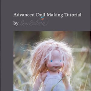 May include: A handmade doll with light pink hair and blue eyes, wearing a white dress, stands in tall grass. The image is from a tutorial titled "Advanced Doll Making Tutorial" by "loulabrea".
