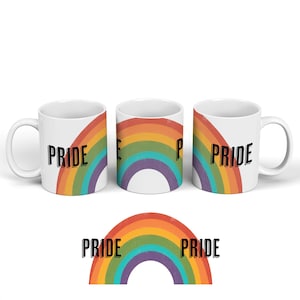 May include: Three white ceramic mugs with a rainbow design and the word "PRIDE" printed on each mug. The rainbow design is in the colors red, orange, yellow, green, blue, indigo, and violet. The mugs are arranged in a row, with the middle mug showing the full rainbow design and the word "PRIDE" on the left and right mugs.