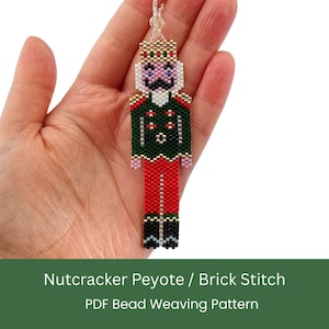 May include: A beaded nutcracker pendant in red, green, gold, and black. The pendant is made using the peyote and brick stitch techniques. The text at the bottom reads "Nutcracker Peyote / Brick Stitch PDF Bead Weaving Pattern."