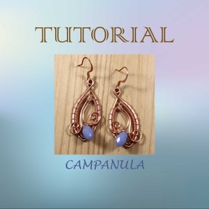 May include: A pair of copper wire earrings with a light blue gemstone in the center of each earring. The earrings are in the shape of a teardrop and have a delicate wire design. The earrings are labeled "Campanula".