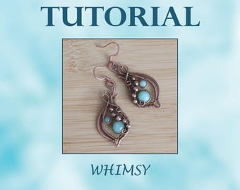 May include: A pair of copper wire earrings with turquoise and copper beads. The earrings are in the shape of a teardrop and have a delicate, whimsical design. The earrings are labeled "WHIMSY" in the image.