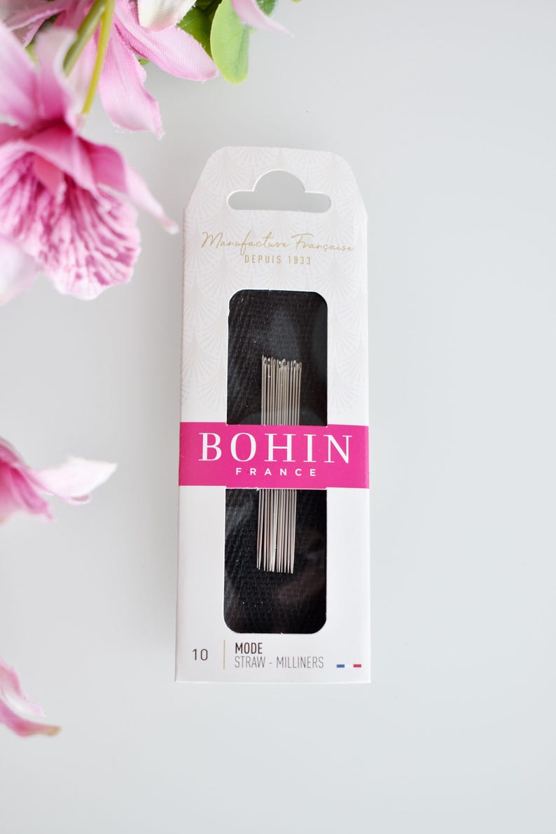 May include: A package of Bohin Mode Straw Milliners needles, size 10, in a white box with pink and black accents. The box features the text "Manufacture Francaise Depuis 1933" and "Bohin France".