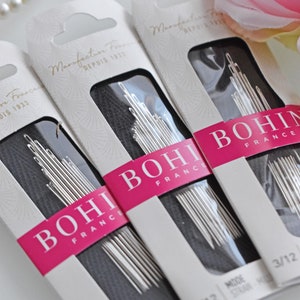 May include: Three packages of Bohin sewing needles, size 3/12, with the text "Manufacture Fran&ccedil;aise Depuis 1833" on the front. The packages are white with pink and black accents.