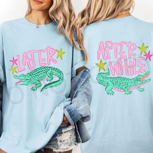 May include: Light blue t-shirt with a green alligator graphic and the text "LATER" on the front. The back of the shirt features the text "AFTER WHILE" and a matching alligator graphic. Pink and yellow stars accent the text.