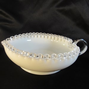 May include: White milk glass bowl with a silver beaded edge and a clear glass handle.