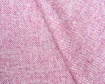 May include: Close-up of a textured fabric with a herringbone pattern. The fabric is a blend of white and a deep rose color, creating a visually interesting texture. The diagonal lines of the weave are clearly visible.