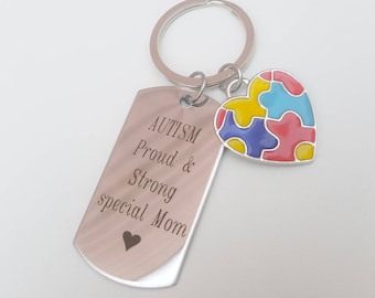 May include: Silver keychain with a tag that reads "AUTISM Proud & Strong special Mom" and a heart-shaped charm with a colorful puzzle piece design.