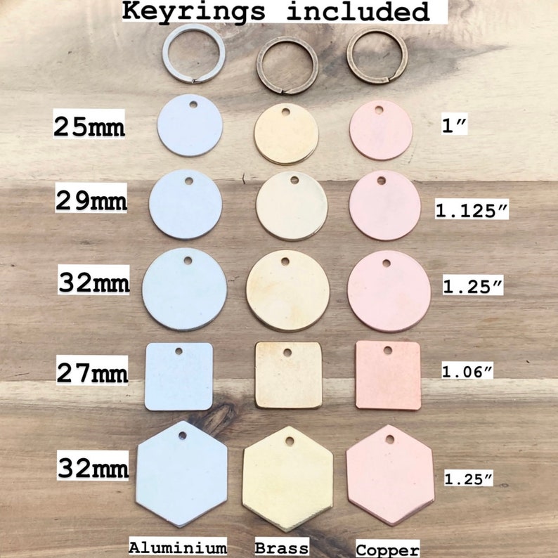 May include: An assortment of metal keyrings and tags in various shapes and sizes. The tags are made of aluminum, brass, and copper, with measurements in inches and millimeters. The text "Keyrings included" is at the top.
