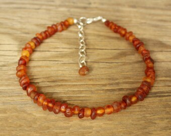 amber necklace on ankle