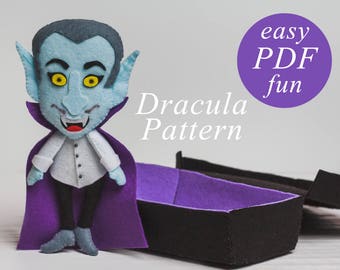 May include: A felt Dracula puppet with a purple cape and a white shirt. The puppet is holding a small coffin. The text "easy PDF fun" and "Dracula Pattern" is visible in the image.
