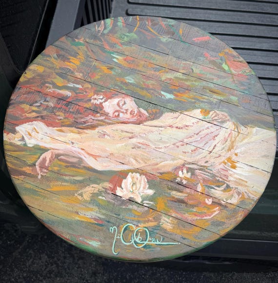 A hand-painted 'Ophelia' bedside table — functional furniture turned into a wearable painting, the kind of heirloom piece that anchors a whole room's personality.