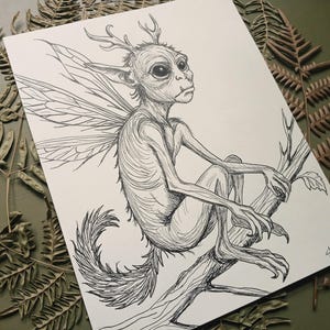 May include: A black and white ink drawing on paper depicting a creature with large dark eyes, pointed ears, small antlers, and insect-like wings. The creature has a slender body, a long furry tail, and is perched on a tree branch. A signature is visible.