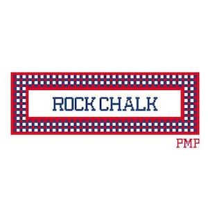 May include: A rectangular design with the text "ROCK CHALK" in navy blue, set against a white background. The border is a red and blue checkered pattern. The letters "PMP" are in the bottom right corner.