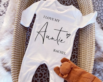 May include: White baby onesie with long sleeves and black text that reads "I love my Auntie Rachel" with a small heart symbol.