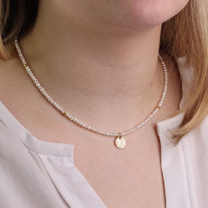 Fine pearl necklace made from real freshwater pearls with a small plate