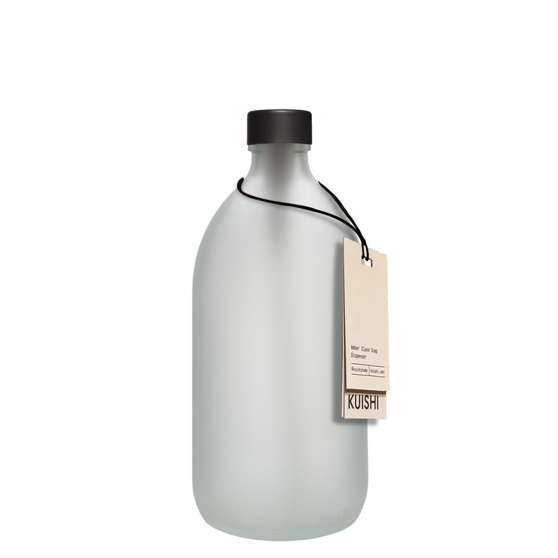 May include: A frosted glass soap dispenser with a black pump top and a brown paper tag that reads "Amber Glass Soap Dispenser" and "KUISHI".