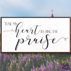 May include: A white wooden sign with brown trim, featuring the text "Tune my heart to sing thy praise" in black cursive font. The sign is displayed against a backdrop of purple lupine flowers.