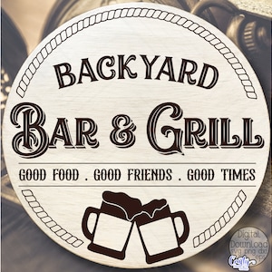 May include: A round wooden sign with a rope border. The sign says "BACKYARD BAR & GRILL" in a decorative font. Below the text, it says "GOOD FOOD. GOOD FRIENDS. GOOD TIMES". Two brown beer mugs with foam are shown at the bottom of the sign.