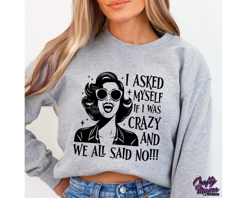 May include: Gray sweatshirt with a black and white graphic of a woman with sunglasses and the text "I asked myself if I was crazy and we all said no!!!"