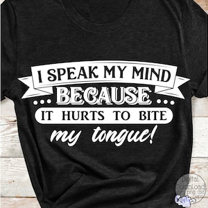 May include: Dark gray t-shirt with the white text: "I SPEAK MY MIND BECAUSE IT HURTS TO BITE my tongue!" The text is in a bold, easy-to-read font. The shirt is a casual style.