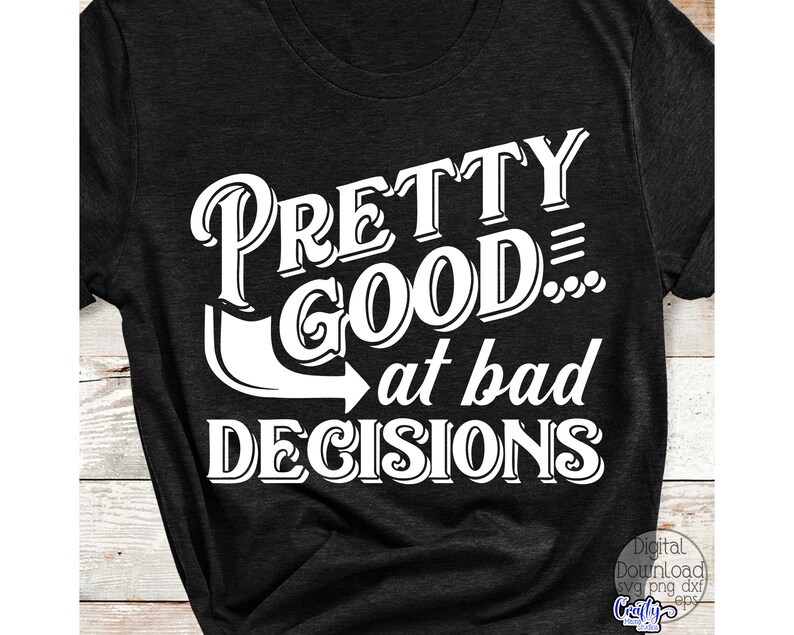 May include: Dark gray t-shirt with the white text "PRETTY GOOD... at bad DECISIONS". The text is in a bold, stylized font. The shirt has short sleeves and a crew neck.
