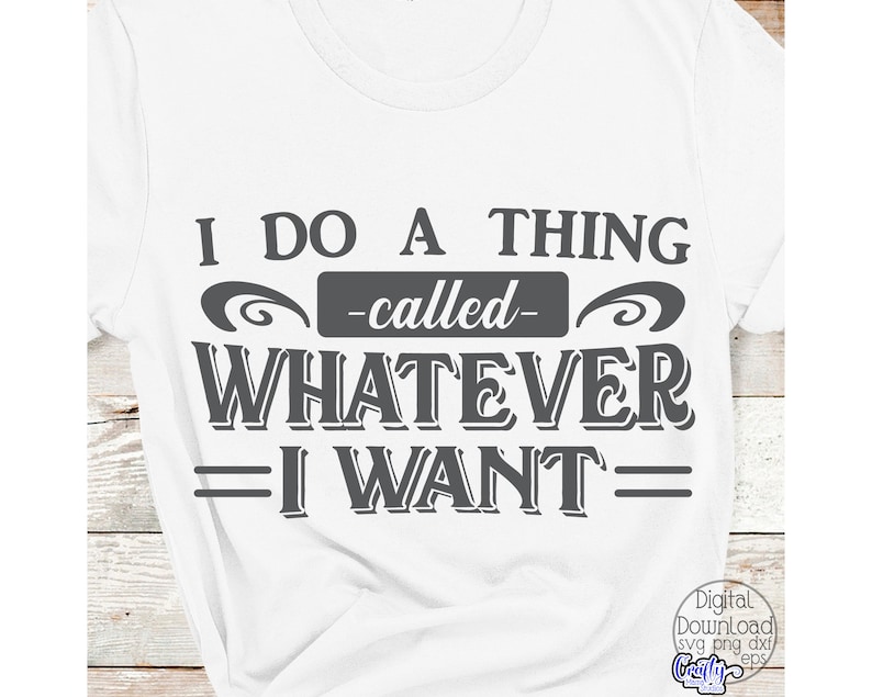 May include: White t-shirt with the phrase "I DO A THING -called- WHATEVER I WANT" in dark gray lettering. The text is centered and features decorative elements. The shirt is a casual wear item.