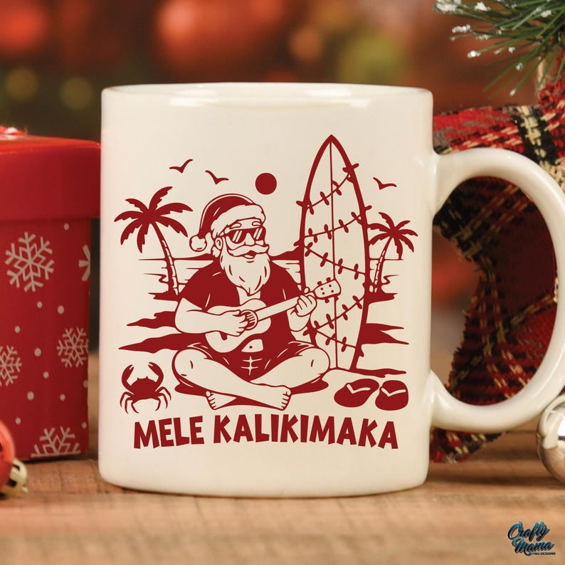May include: White ceramic mug with a red illustration of Santa Claus playing a ukulele on a beach, wearing sunglasses and a Santa hat. The mug has the text "MELE KALIKIMAKA" in red. Palm trees, a surfboard, and a crab are also depicted.