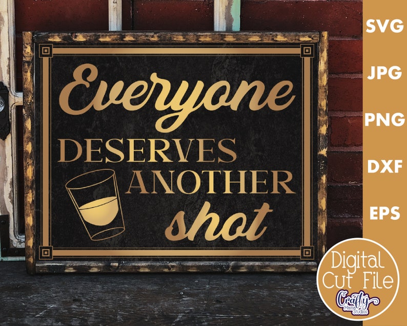 May include: A rustic wooden sign with a gold frame and black background. The sign reads "Everyone Deserves Another Shot" with a gold shot glass graphic.